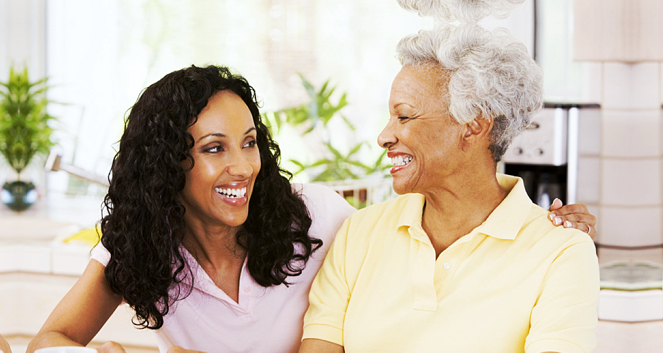 caregiver and senior woman smiling