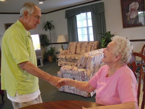 old man and old woman having a handshake